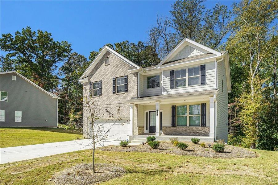 Front exterior of a new home in Paces Estates, Lithia Springs, GA, highlighting curb appeal (Image 1). Front exterior of a new home in Paces Estates, Lithia Springs, GA, highlighting curb appeal (Image 1).