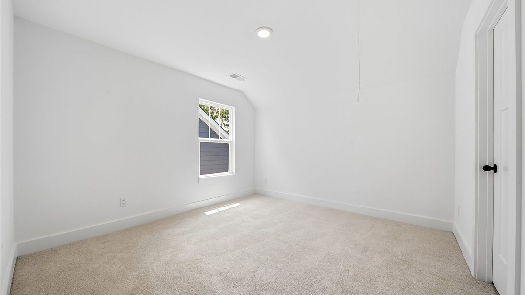 Elegant bedroom retreat featuring soft carpet and oversized windows that create a bright, welcoming space Elegant bedroom retreat featuring soft carpet and oversized windows that create a bright, welcoming space