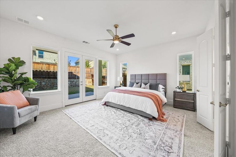 Bedroom featuring ceiling fan, access to exterior via French doors, light carpet, and recessed lighting Bedroom featuring ceiling fan, access to exterior via French doors, light carpet, and recessed lighting