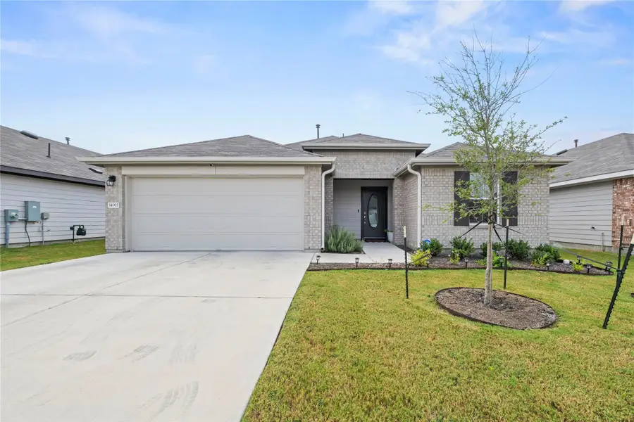 A charming single-story residence with a well-maintained lawn and an inviting front entrance.