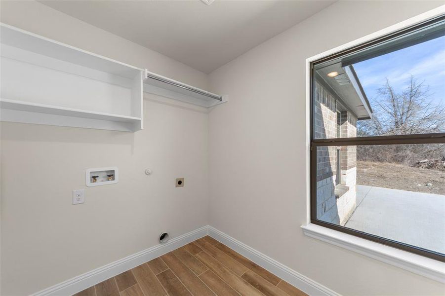 Laundry area featuring gas dryer hookup, wood tiled floors, electric dryer hookup, and washer hookup