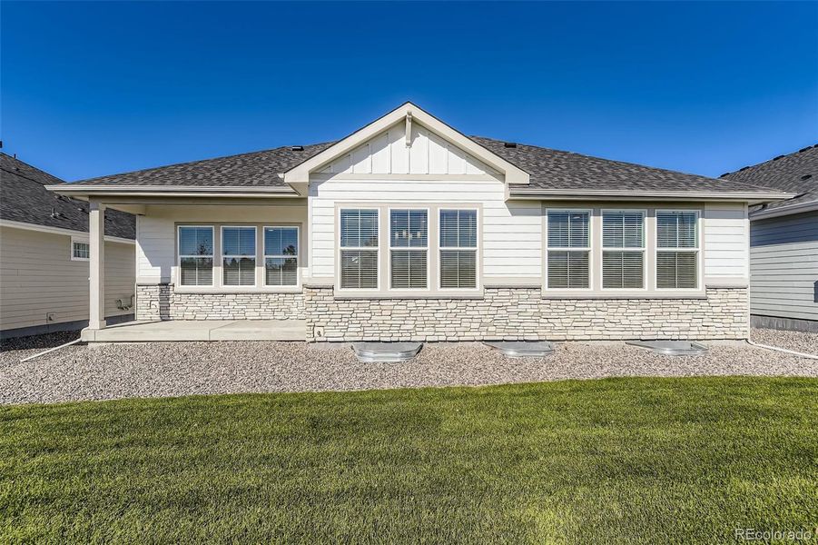 Exterior details and patio area of a home in Hilltop 55+ at Inspiration 62s, Aurora (Image 18).