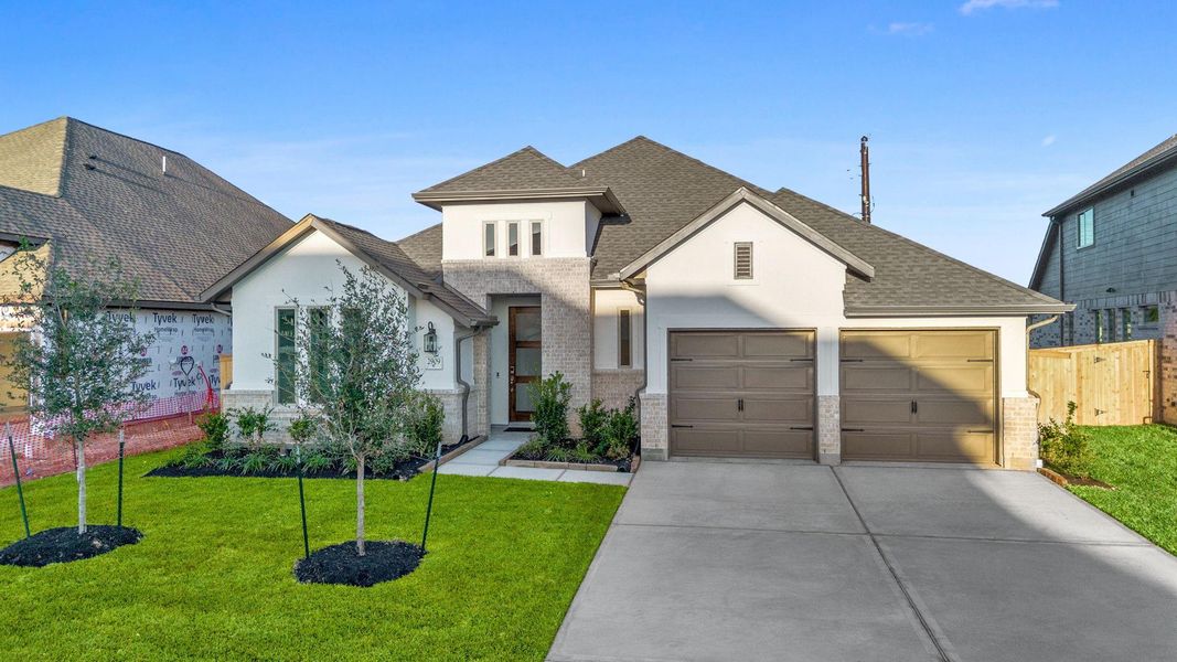 Front exterior of a new home in Coastal Point, League City, TX, highlighting curb appeal (Image 1).