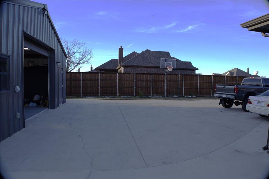 New Addition - Fenced yard with basketball hoop and a patio area