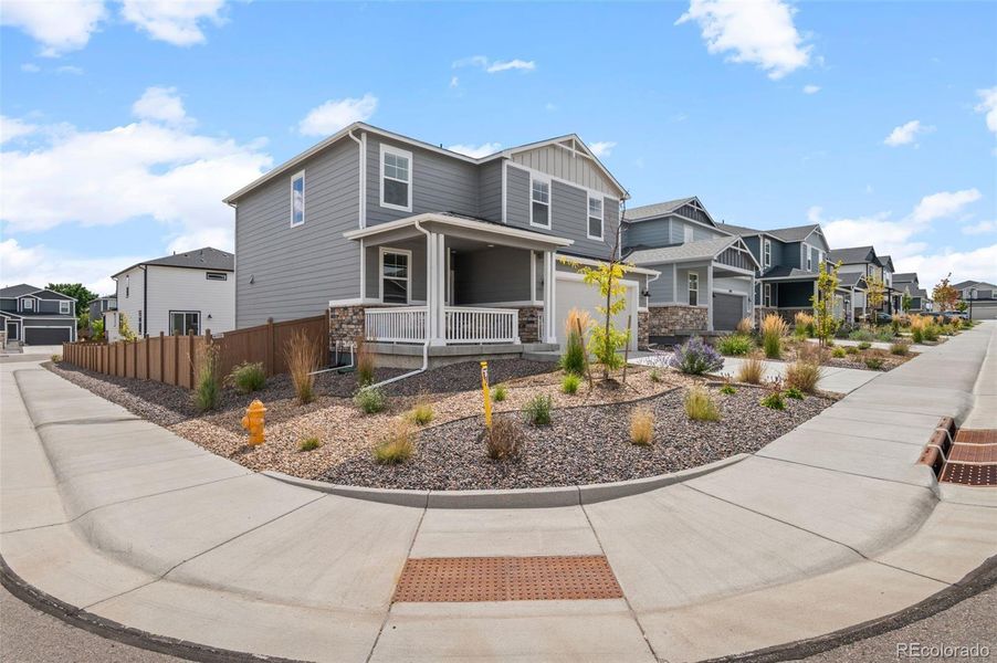 Front exterior of a new home in Sunstone Village at Terrain, Castle Rock, CO, highlighting curb appeal (Image 20).