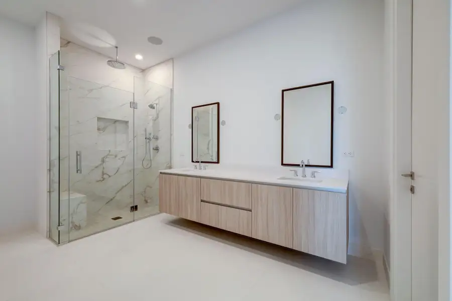 Primary Bathroom features Pedini cabinets, double sink vanity, walk in porcelain edgeless shower and private water closet. Primary Bathroom features Pedini cabinets, double sink vanity, walk in porcelain edgeless shower and private water closet.