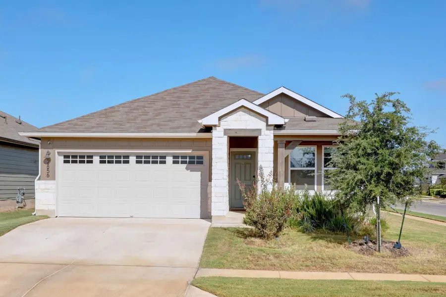 View of front of property with concrete driveway, a garage, stone siding, a shingled roof, and board and batten siding View of front of property with concrete driveway, a garage, stone siding, a shingled roof, and board and batten siding