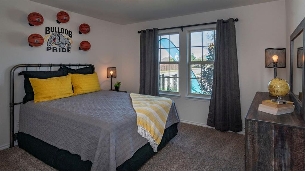 Bedroom featuring dark colored carpet and baseboards