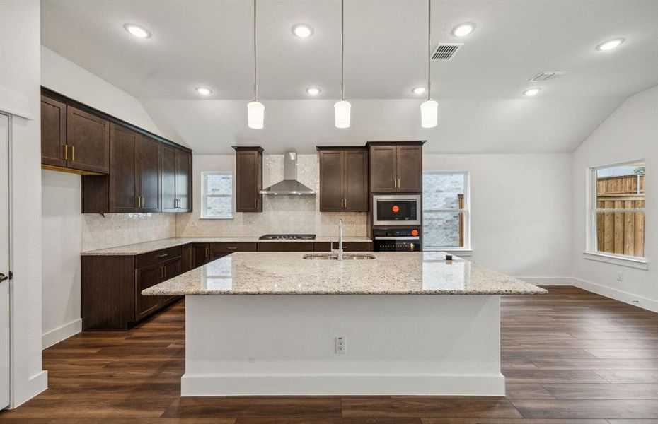 Airy kitchen with oversized island *real home pictured