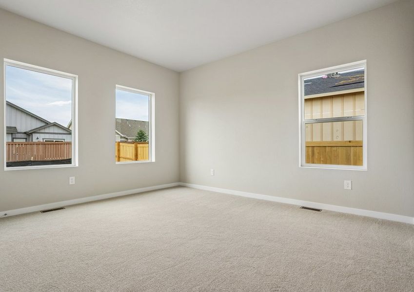 The master bedroom has large windows and carpet,