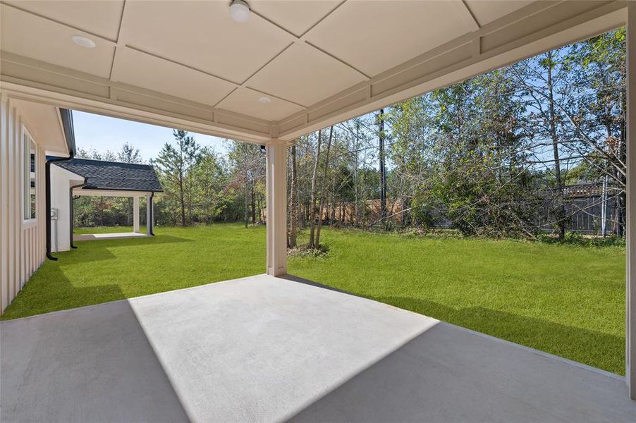 Large covered patio w/patio doors leading into the den.