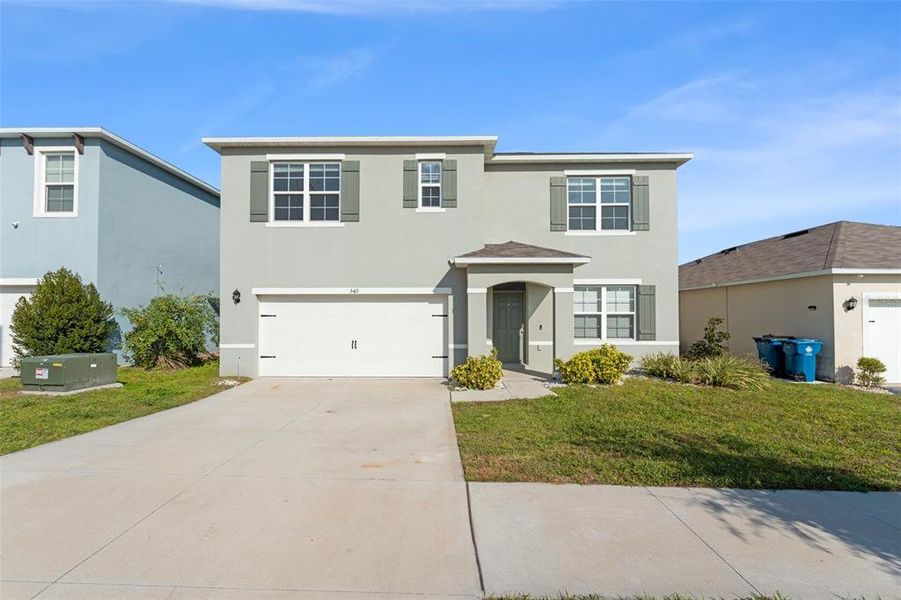 Front exterior of a new home in Grace Ranch, Haines City, FL, highlighting curb appeal (Image 2). Front exterior of a new home in Grace Ranch, Haines City, FL, highlighting curb appeal (Image 2).