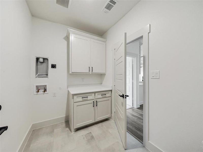 Laundry room with room for stackable washer and dryer and freezer. Built-in cabinets Laundry room with room for stackable washer and dryer and freezer. Built-in cabinets
