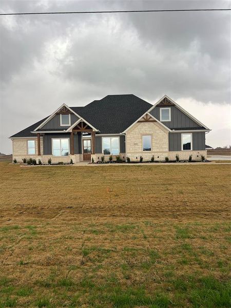 Craftsman-style house with a front lawn