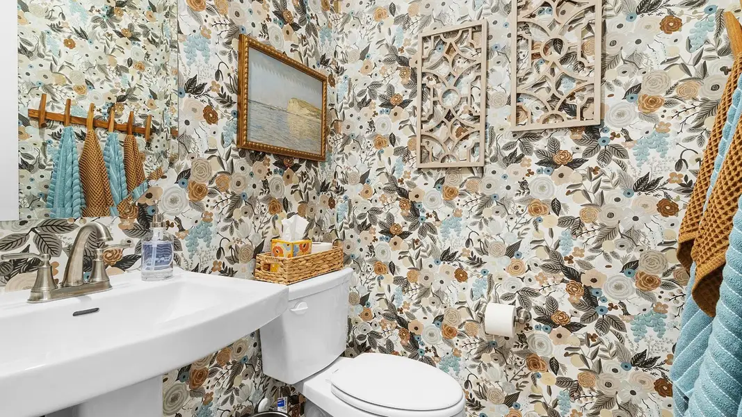 Bold floral wallpaper enlivens this compact, well-appointed half bath. Bold floral wallpaper enlivens this compact, well-appointed half bath.