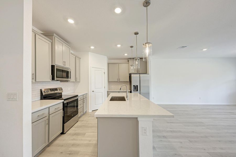 Bright, modern kitchen with an inviting island and sleek stainless steel appliances.