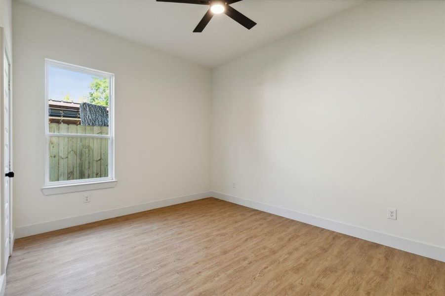 Spare room with ceiling fan and light hardwood / wood-style floors