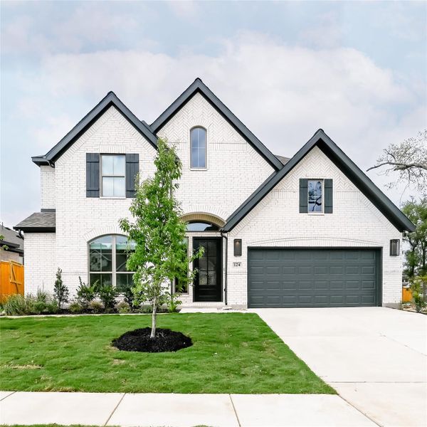 Front exterior of a new home in 6 Creeks, Kyle, TX, highlighting curb appeal (Image 21).