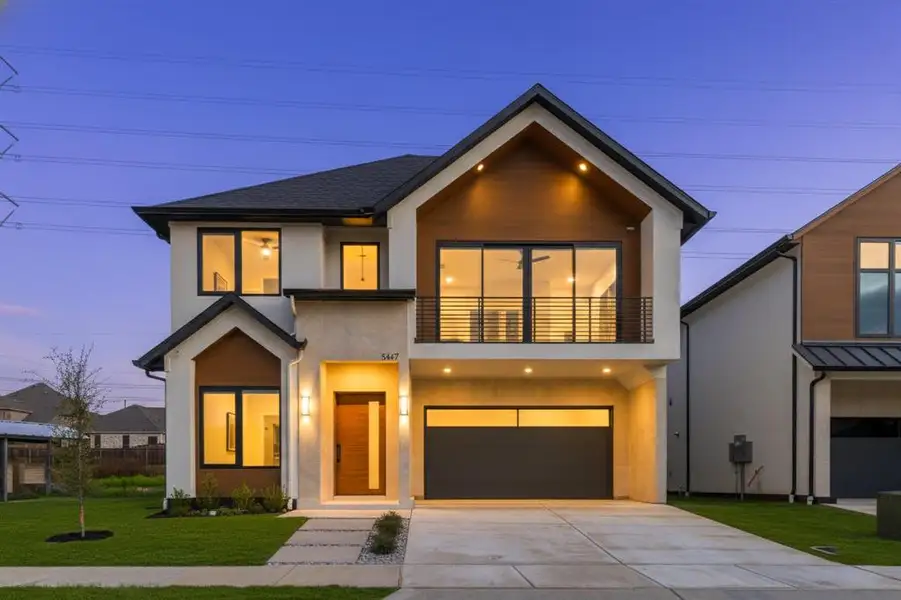 Contemporary house featuring a balcony, a front yard, concrete driveway, stucco siding, and a shingled roof