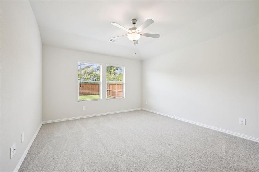 Room featuring light carpet, ceiling fan, and lofted ceiling