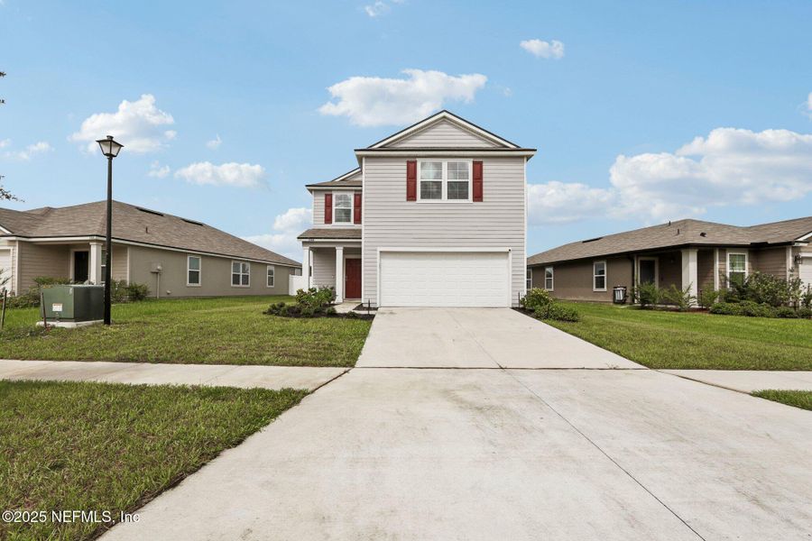 Front exterior of a new home in Cross Creek Express, Green Cove Springs, FL, highlighting curb appeal (Image 25).