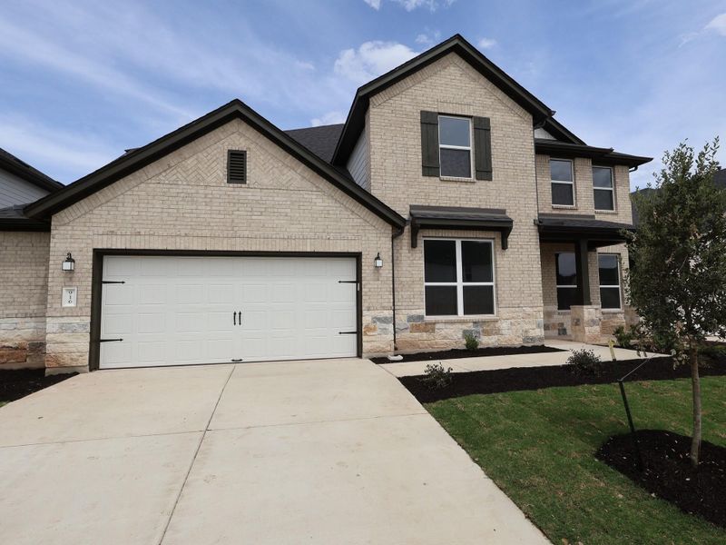 Front exterior of a new home in Edgewood, Leander, TX, highlighting curb appeal (Image 1). Front exterior of a new home in Edgewood, Leander, TX, highlighting curb appeal (Image 1).
