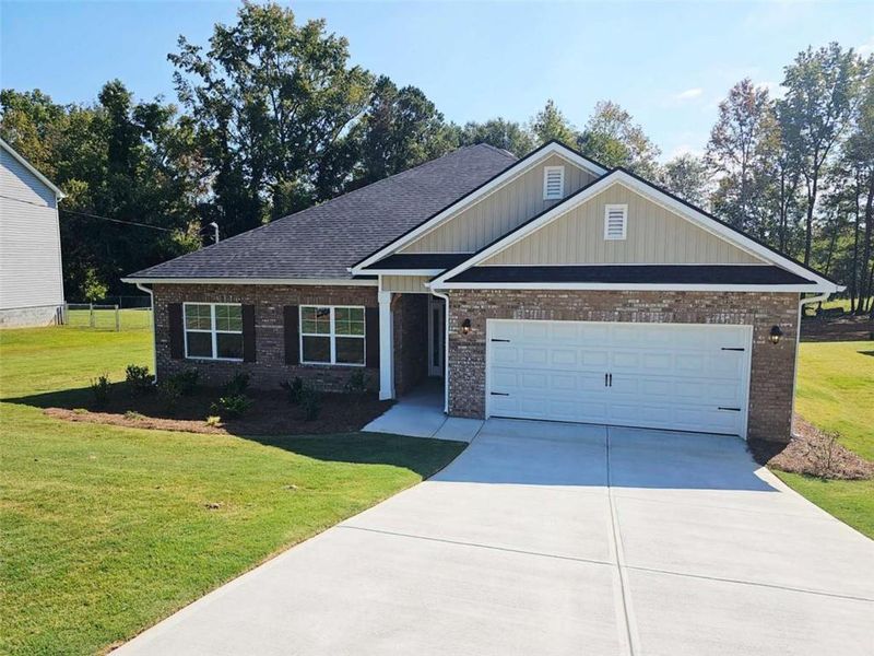 Front exterior of a new home in Scarlett Place, Bowdon, GA, highlighting curb appeal (Image 1).