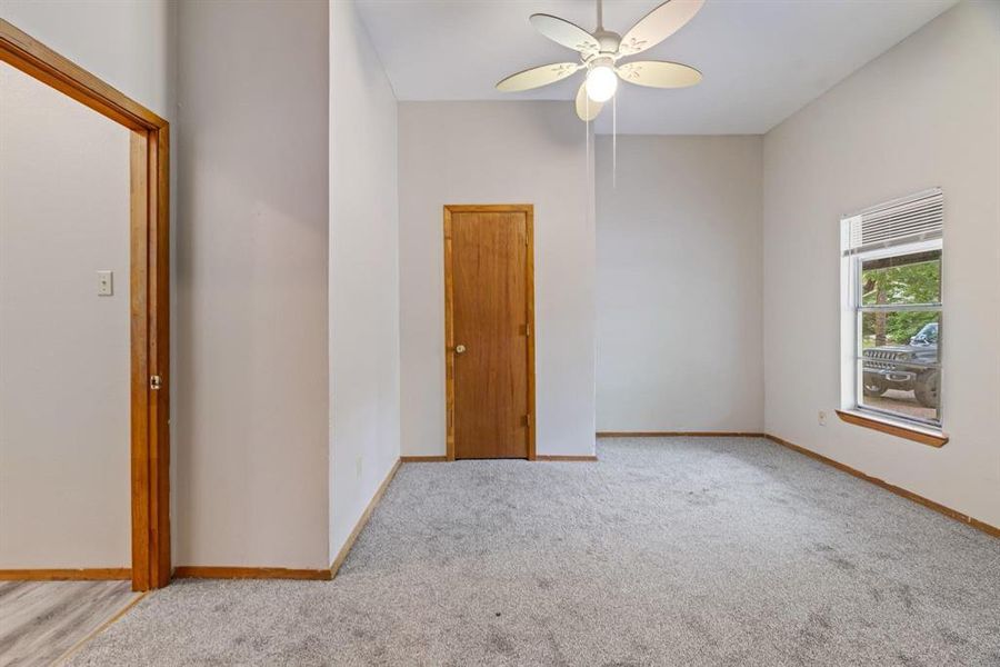 Spare room with a ceiling fan and carpet flooring Spare room with a ceiling fan and carpet flooring