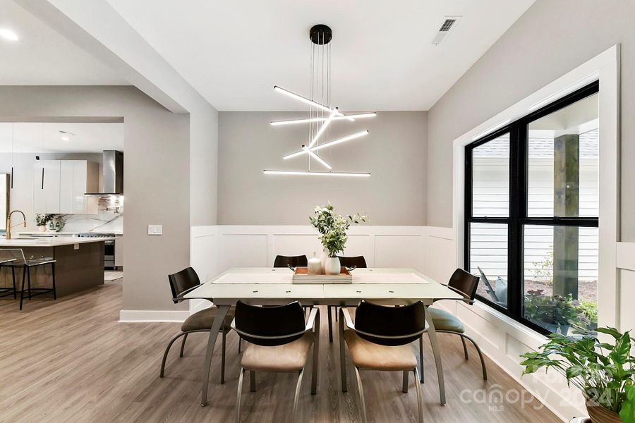 Formal Dining features custom, modern light fixture & beautiful finishes!