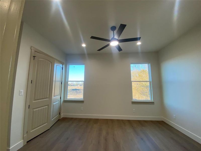 Unfurnished room with hardwood / wood-style floors and ceiling fan