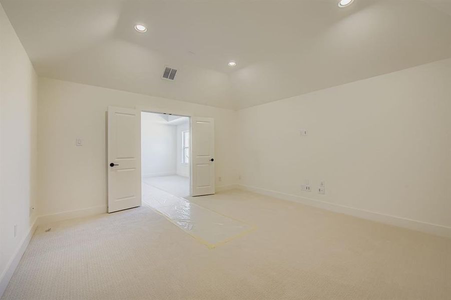 Carpeted spare room with recessed lighting and lofted ceiling Carpeted spare room with recessed lighting and lofted ceiling