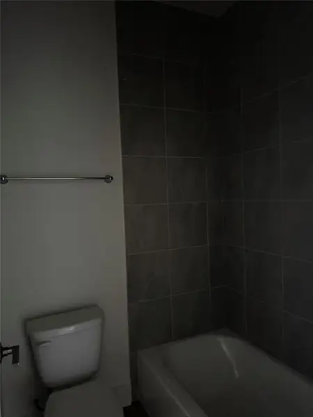 Full bath featuring toilet and shower combination Full bath featuring toilet and shower combination