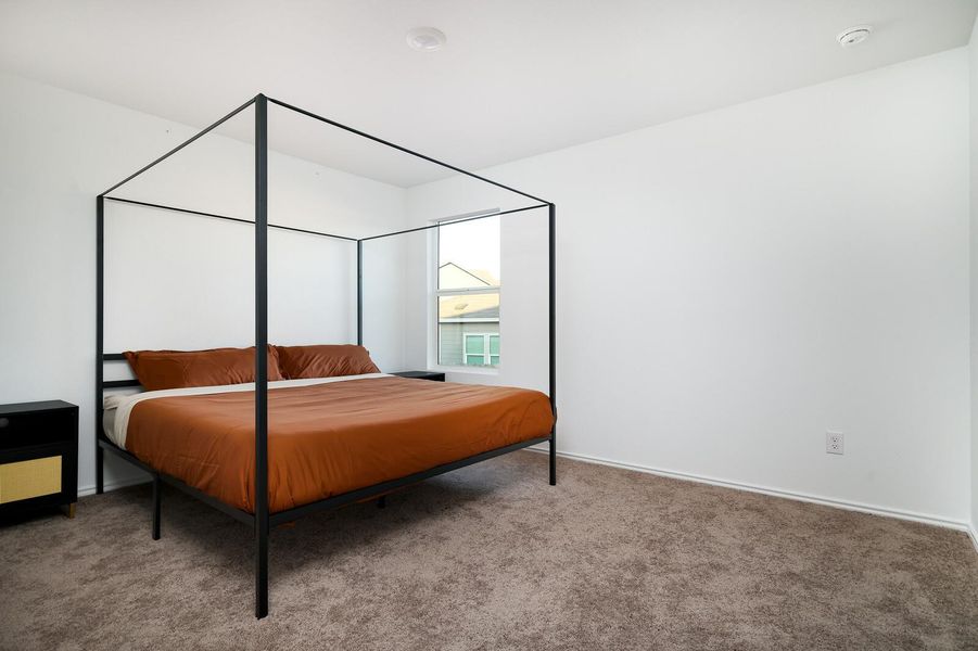 Bedroom featuring carpet and baseboards Bedroom featuring carpet and baseboards