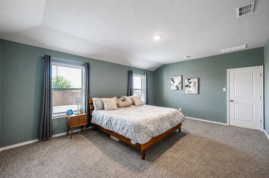 Carpeted room featuring a vaulted ceiling and recessed lighting