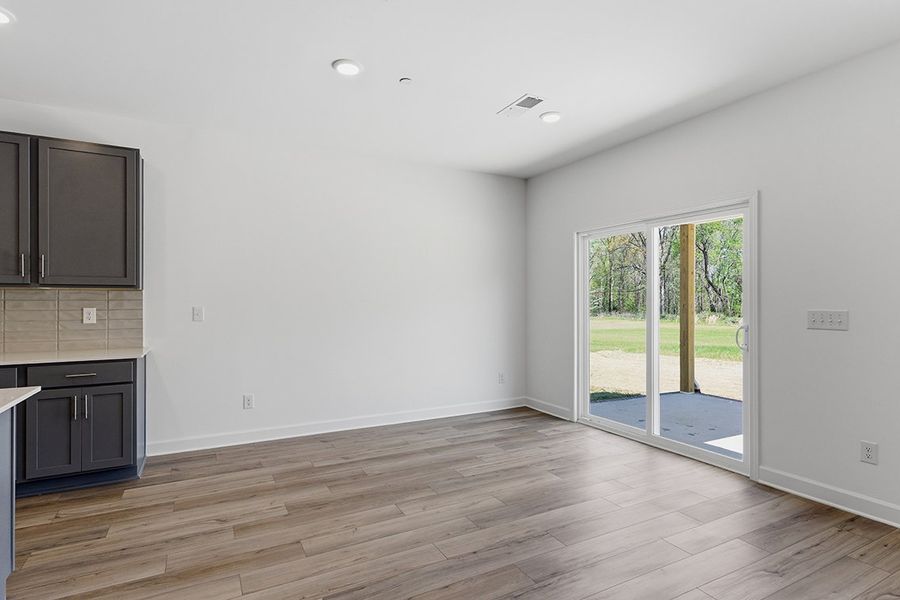 A room with a wood floor and a glass door. A room with a wood floor and a glass door.
