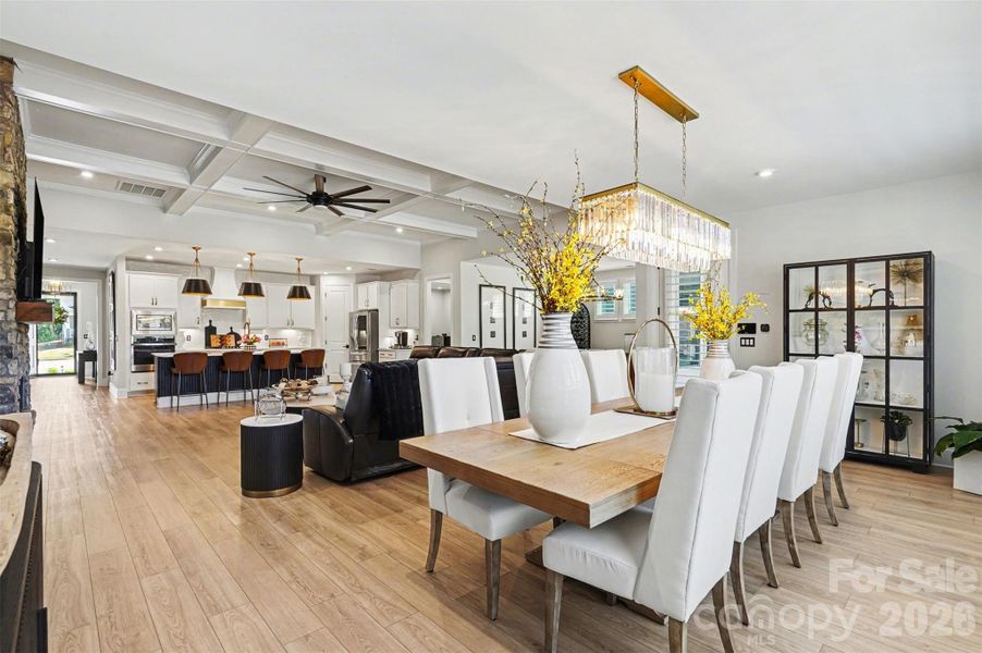 A sophisticated dining area seamlessly integrated into the great room and kitchen, embracing a true open-concept layout that enhances flow and connectivity throughout the living space.