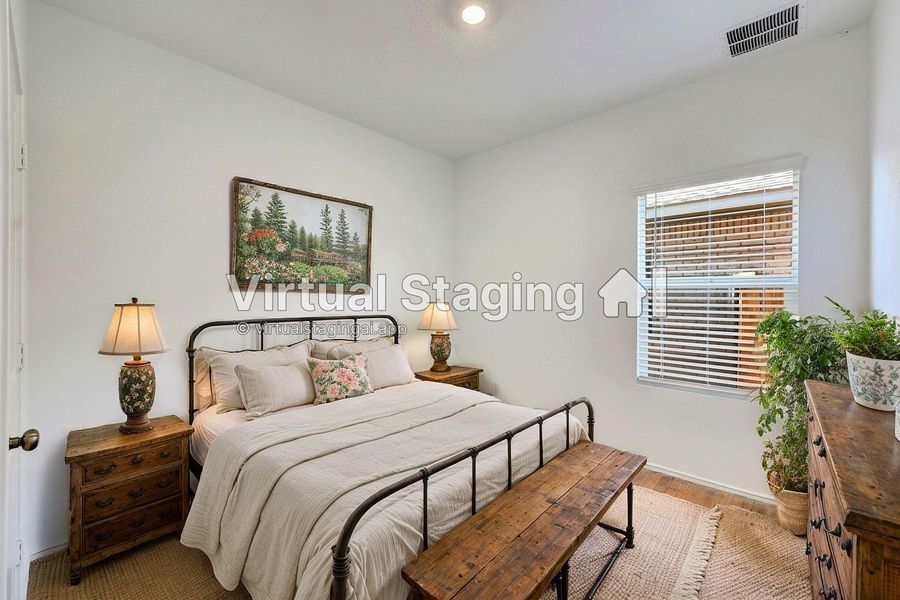 Bedroom featuring baseboards and wood finished floors
