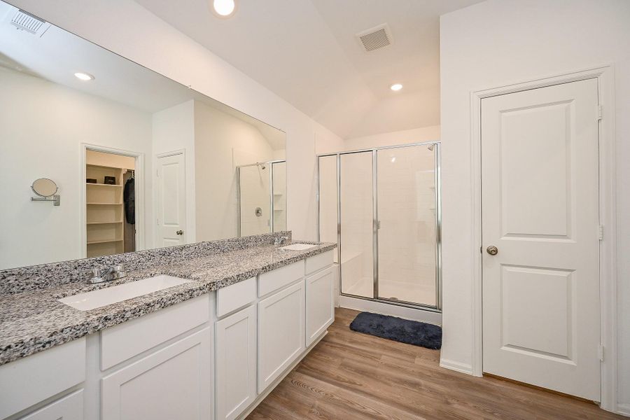 Step into a bright, modern sanctuary designed for both functionality and style. This spacious bathroom features a double-sink vanity topped with a sleek granite countertop, complemented by crisp white cabinetry that offers ample storage for daily essentials Step into a bright, modern sanctuary designed for both functionality and style. This spacious bathroom features a double-sink vanity topped with a sleek granite countertop, complemented by crisp white cabinetry that offers ample storage for daily essentials