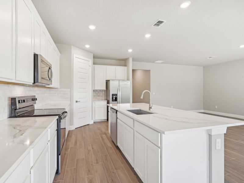 Kitchen in the Emilia floorplan at 8993 Dahlia Circle