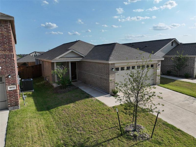 Brick and siding exterior featuring a two-car garage with overhead lighting, a covered entry, and a concrete driveway Brick and siding exterior featuring a two-car garage with overhead lighting, a covered entry, and a concrete driveway