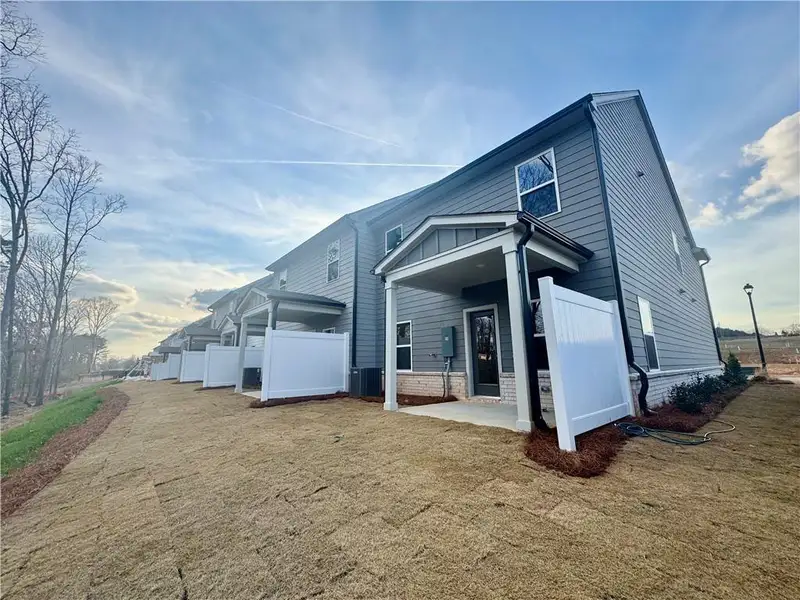 Exterior details and patio area of a home in Eastlyn Crossing, Flowery Branch (Image 3).