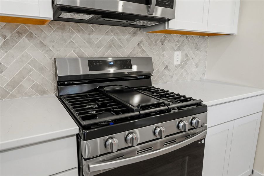 Modern stone countertops flank a premium gas range