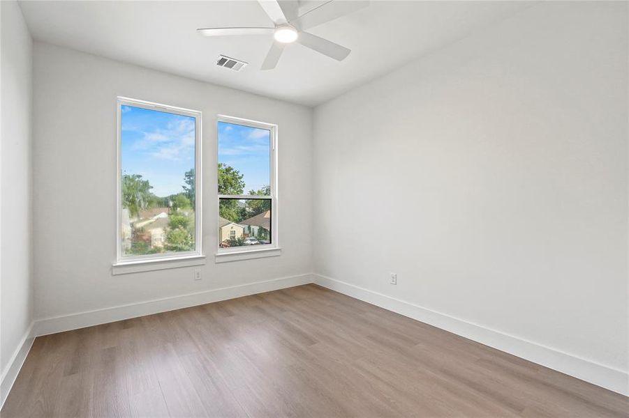 Unfurnished room with wood finished floors and ceiling fan