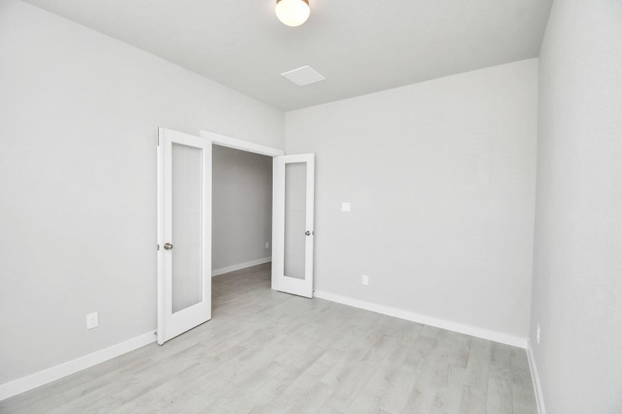 Step into the inviting home office, where elegant tile flooring adds a touch of freshness and comfort to the workspace. Natural light pours through the window, creating an inspiring environment for productivity and focus. Sample photo of completed home with similar floor plan. Actual colors and selections may vary.