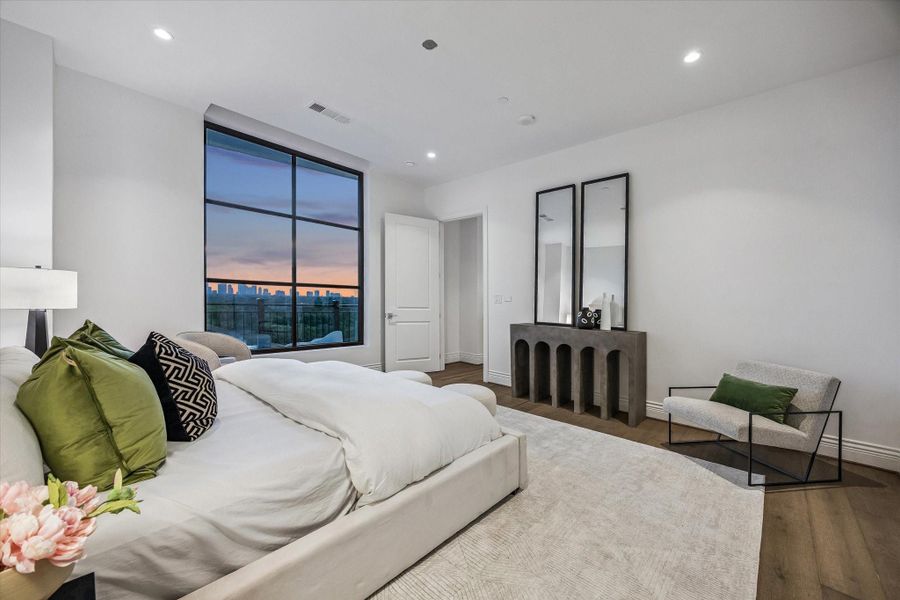 A spacious and well-appointed primary bedroom features high ceilings, a generous layout, and a calming ambiance, ideal for rest and relaxation.