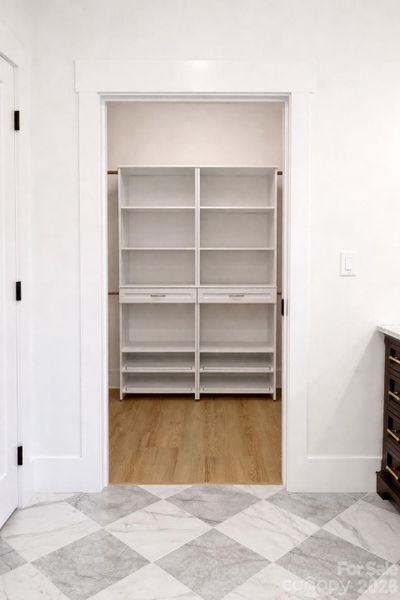 Primary bedroom walk-in closet