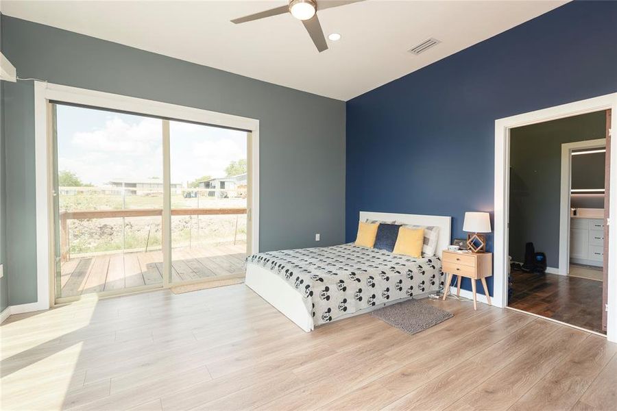 Bedroom featuring access to outside, wood finished floors, ceiling fan, and recessed lighting Bedroom featuring access to outside, wood finished floors, ceiling fan, and recessed lighting
