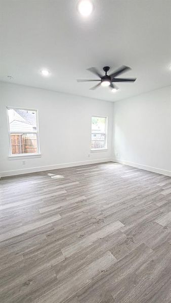 Master bedroom with ceiling fan and light hardwood / wood-style flooring