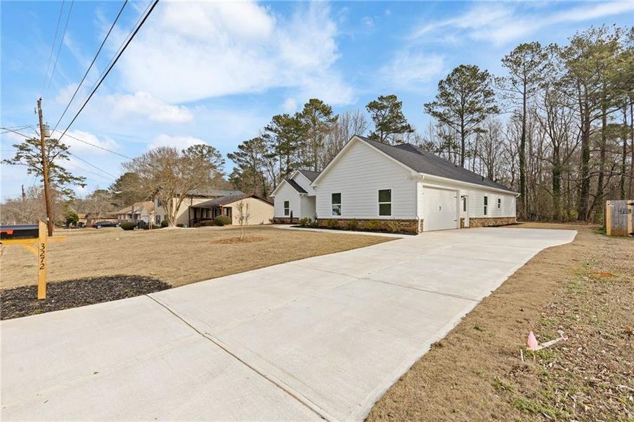 Front exterior of a new home in , Lithonia, GA, highlighting curb appeal (Image 21).