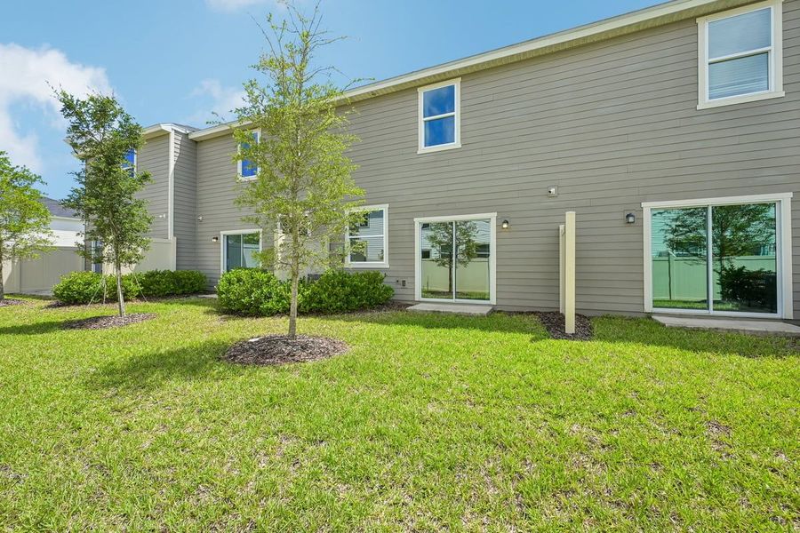 Exterior details and patio area of a home in Orchard Park Townhomes, St. Augustine (Image 3).